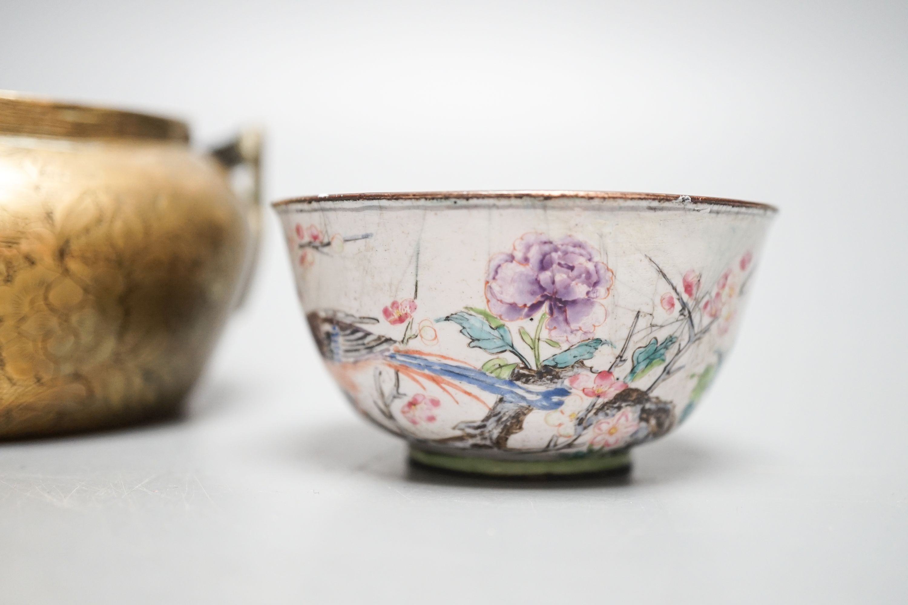 A Chinese bronze hand warmer, 11.3cm and an 18th century Chinese Canton enamel cup